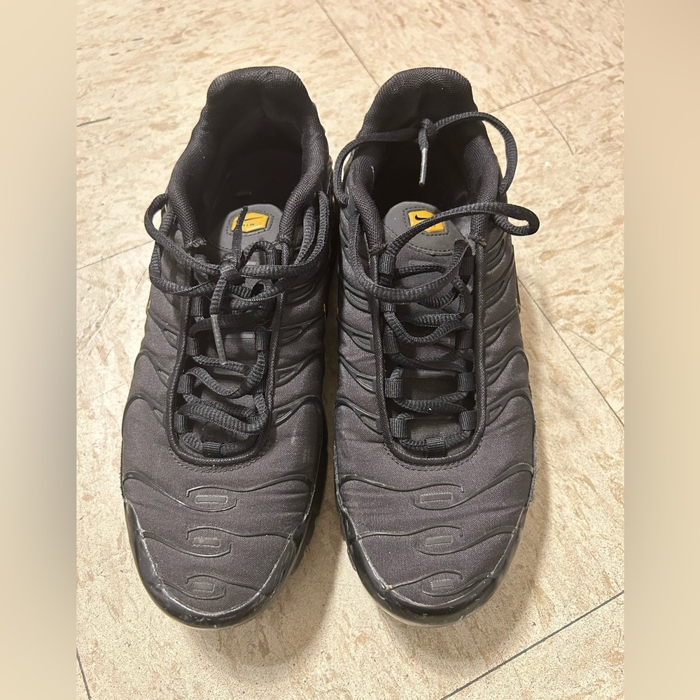 Black and gold Nike shoes